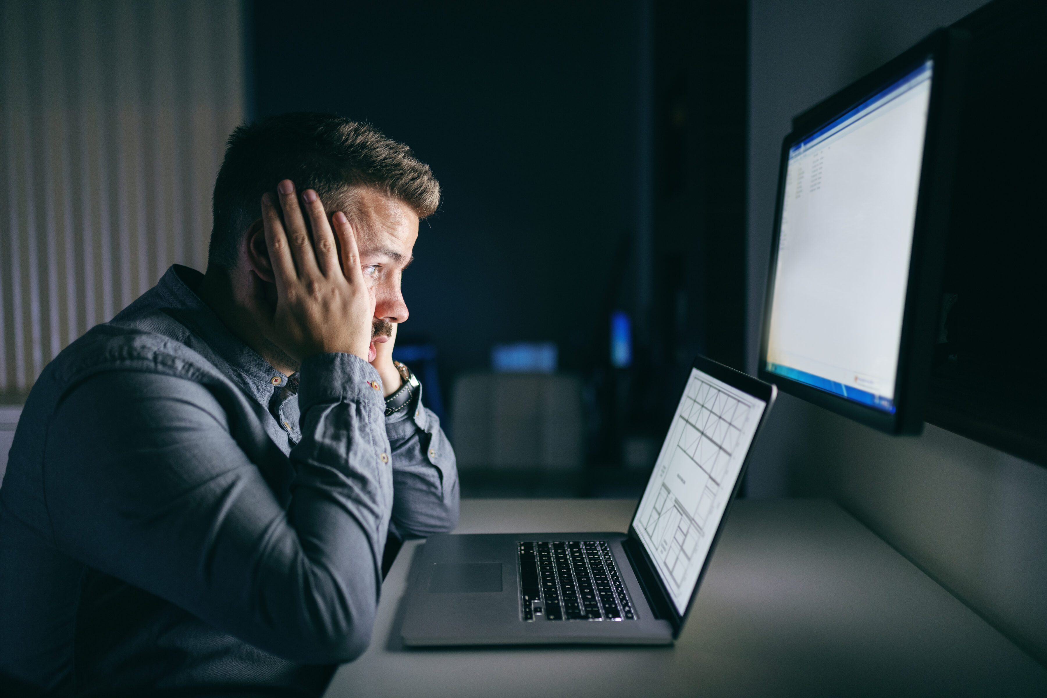 worried man in front of computer identity fraud